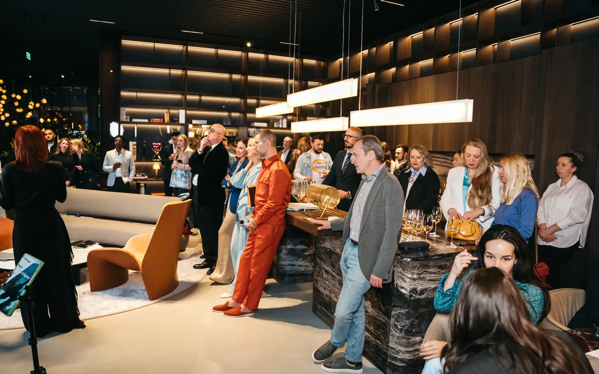 Guests assembled in a lounge for a club gathering.